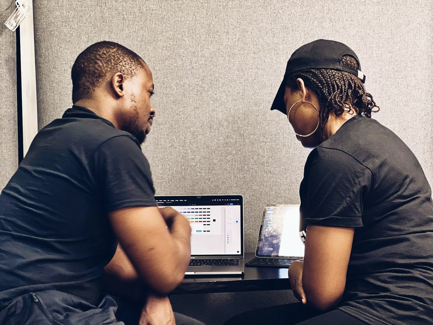 Two colleagues reviewing data together on a laptop