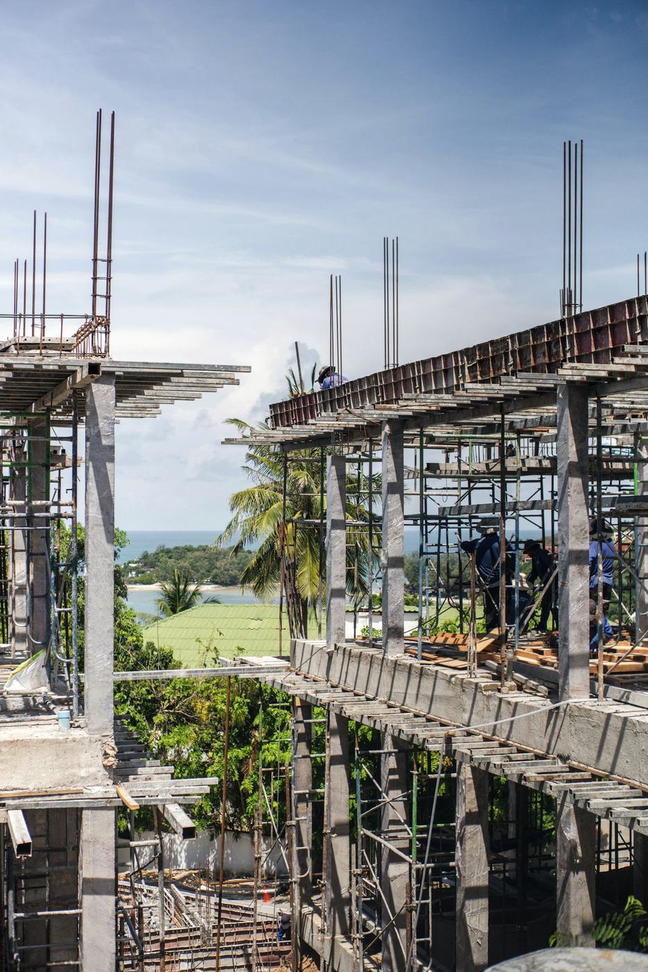 Building under construction with scaffolding and concrete frame